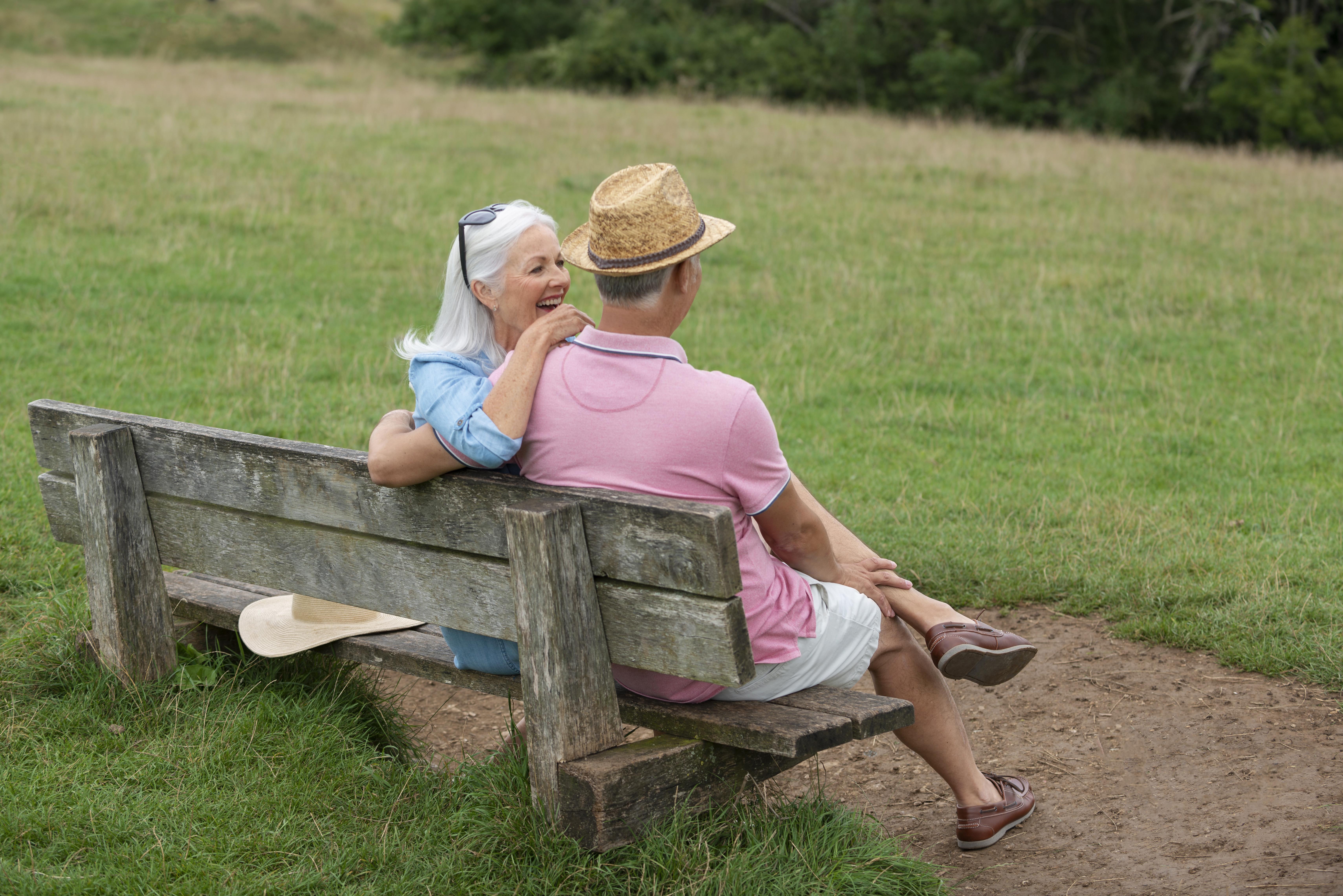 adorable senior couple sitting bench
