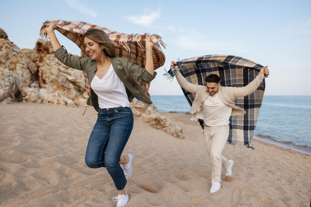 full shot romantic couple with plaid blanket