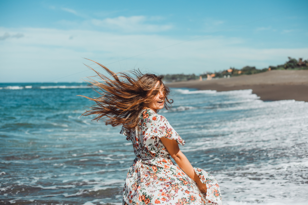 young beautiful girl posing beach ocean waves bright sun tanned skin